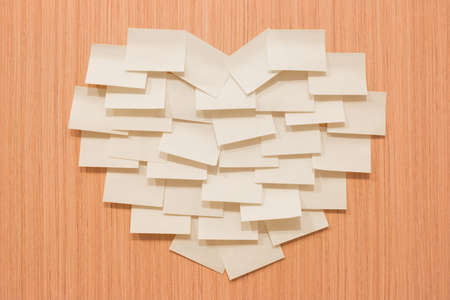 Post it sort heart shape on wooden board - vintage effectの写真素材