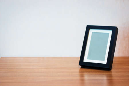 Blank black picture frame at the desk - vintage style effect pictureの写真素材