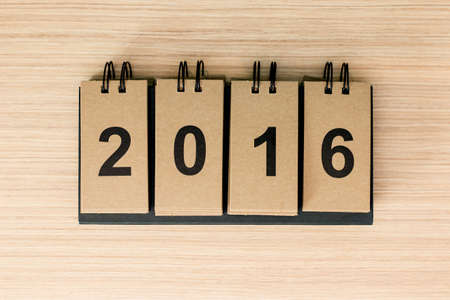 New Year 2016 is coming concept. The word 2016 on wooden background.