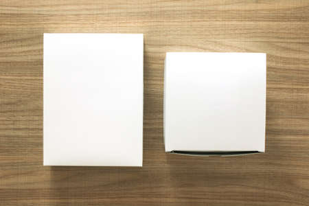 A empty(blank) white box on the desk(table) top view at the studio.の写真素材