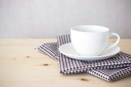 Background with coffee cup on tableclothの写真素材