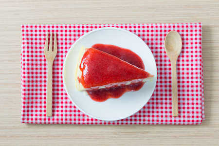 Crape cake pour with strawberry sauce on plateの写真素材