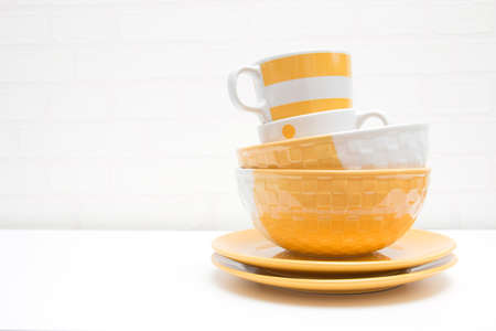 Stack of Plates and Bowls with Cup Background Concept with Custom Spaceの写真素材