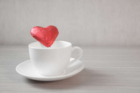 Heart in a cup on wooden table - red only effect style pictureの写真素材