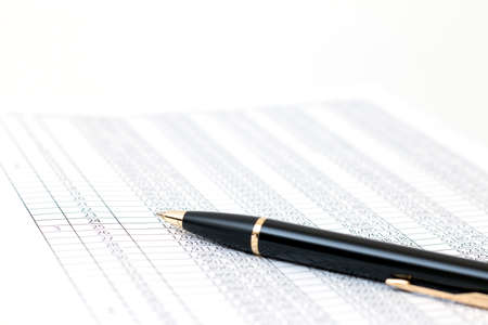 Bookkeeping concept. Closeup of pen on paper background with digitsの写真素材