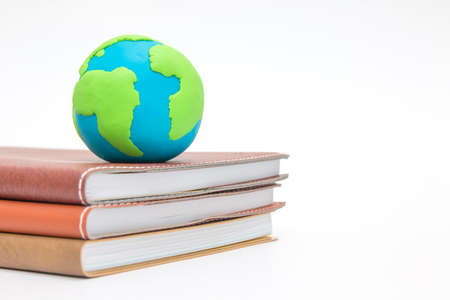 Globe on books - environment and ecology concept with clay earthの写真素材