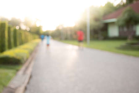 blurred backgrounds of people exercise at parks outdoor:blur of people running,walking,jogging at park:blur of nature park outdoor:blur and out of focus concept:blurred of sport and activity concept.の写真素材