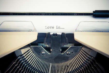 typewriter with white paper. Love is signの写真素材