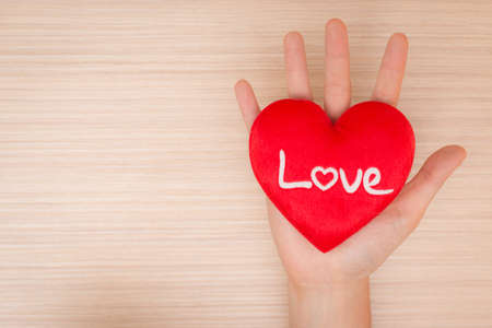 Hand giving red heartの写真素材