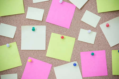 cork board with many sticky notes pinned. vintage effect style picture.の写真素材