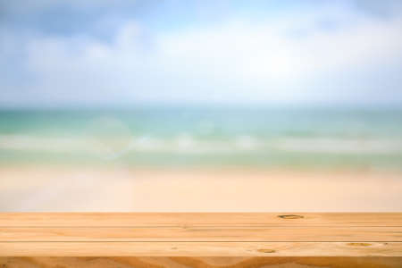Empty wooden table over sea background. Ready for product display montage.