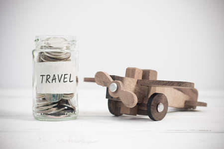 Travel concept with wooden airplane toy. Planning summer vacation, money budget trip concept.の写真素材