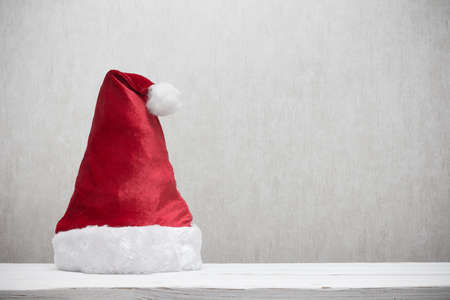 Santa hat on wooden table with copy spaceの写真素材