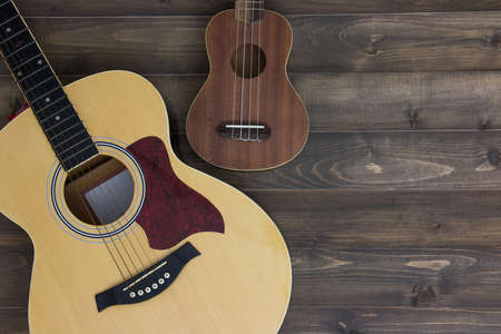 Musical instruments guitar ukulele on old wooden background with copy space. Vintage effect.の写真素材