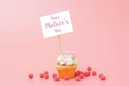 Happy Mothers Day cupcake with heart shape topper and sample text title greeting.の写真素材