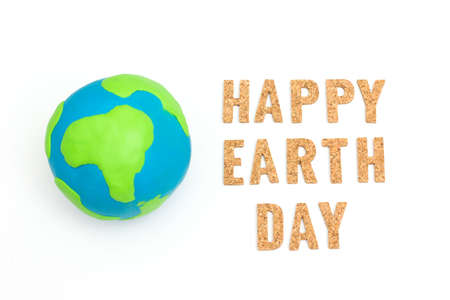 Globe ,earth made from clay and letter happy earth day on white background. Concept Save green...