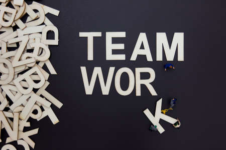 A conceptual photo with a team of workers and word, which represents teamwork.の写真素材