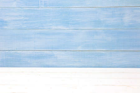 White table and blue wall wooden plank texture backgroundの写真素材