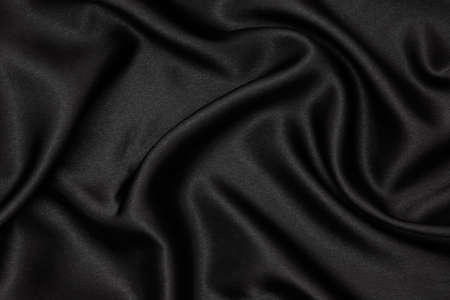 Black fabric texture background. Smooth elegant black silk can use as wedding background.の写真素材