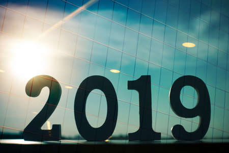The double exposure image of Happy New Year 2019 overlay with window building image and sun flare. 2019 business concept.の写真素材