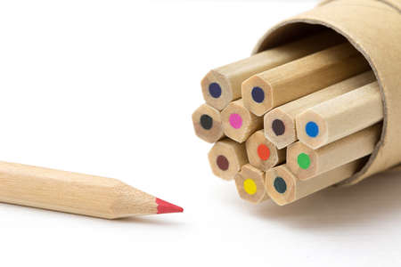 Red pencil standing out from crowd on white table. Leadership, uniqueness, independence, initiative, strategy, dissent, think different, business success concept.の写真素材