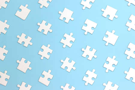 White puzzle pieces on a blue backgroundの写真素材
