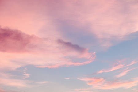 Pink cloud on blue sky. Soft pastel filter.の写真素材