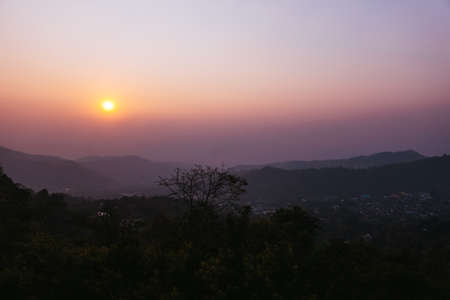Beautiful sunset sky over forest and mountainの写真素材