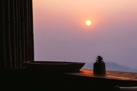 View through window of beautiful sunset sky over forest and mountainの写真素材