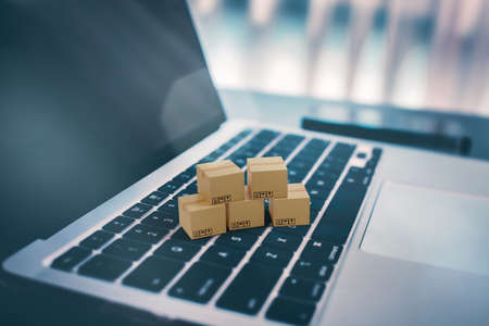Brown paper boxs with laptop on table in office background. Online shopping and delivery service conceptの写真素材