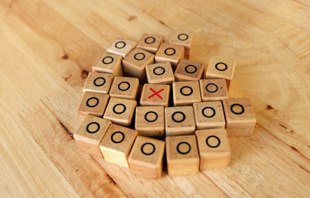 right with tic tac toe game on the wood table
