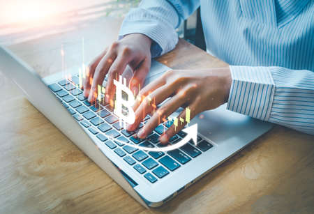 Cryptocurrency Investment with blockchain technology, bitcoin on candle graph, trade uptrend, save and make a profit with interest, Finance And Investment Concept, woman is typing laptop.の写真素材