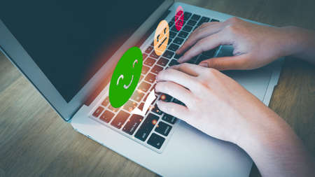Concept of customer's satisfaction and service, businesswoman using laptop to express their opinions, answers and satisfied scores.の写真素材