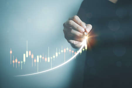Investors are analyzing stocks. Businessman or trader is planning investment and business, stock market growth, forex trading, candlestick strategy, investment progress and success, cryptocurrency.の写真素材