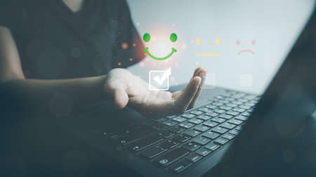 Customer satisfaction very good service by laptop, impression of take care and attention, choose a excellence face icon, answer the survey, give the highest score, very happy feedback from guest.の写真素材