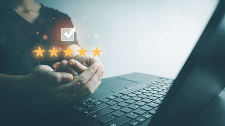 Customer satisfaction assessment rating 5 stars by laptop, User has received excellent service, Review the highest rated service, the best attention, impressed very good service, feedback from guest.の写真素材