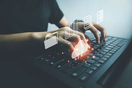 Officer using laptop manage files, Document Management System (DMS), Online document database management, automated processes to manage system, ERP enterprise efficient, business technology.の写真素材