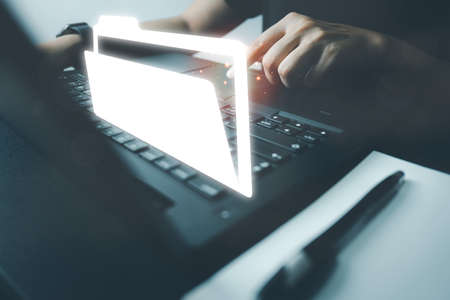 Officer using laptop manage files, Document Management System (DMS), Online document database management, automated processes to manage system, ERP enterprise efficient, business technology.の写真素材