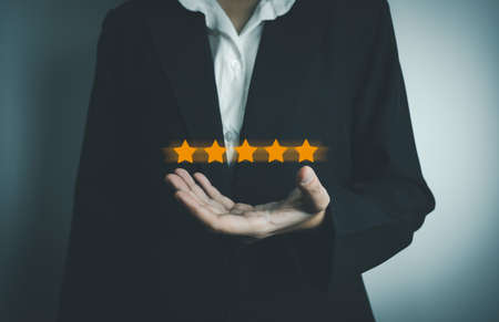 Businesswoman rate satisfaction 5 stars, Excellent quality assurance, certification the best service, guarantee standard company service. ISO certification, satisfaction of customerの写真素材