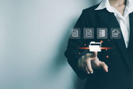 Businesswoman use finger touch screen folder manage file,online data management,Document Management System DMS,access to document file with security,structure design document,ERP enterpriseの写真素材