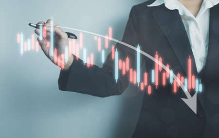 Investor analyze stock chart, Businesswoman forecast graph in Bearish downtrend, Inflation Effect,Economic Depression, War effect Russia and Ukraine, trade war finance, covid-19 impactの写真素材
