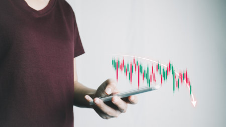 Investor analyze stock chart by smartphone,Businesswoman forecast graph in Bearish downtrend,Inflation Effect,Economic Depression, War effect Russia and Ukraine, trade war finance, covid-19 impactの写真素材