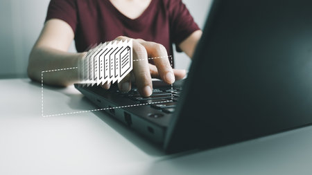 Officer using laptop manage files, Document Management System, Online document database management, automated processes to manage system, ERP enterprise efficient, business technology.の写真素材