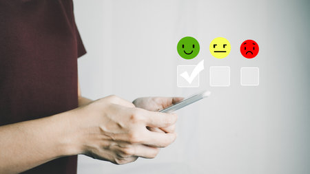 Customer satisfaction very good service with smart phone, impression of take care and attention, choose a smiley face icon, answer the survey, give the highest score, very happy feedback from guest.の写真素材