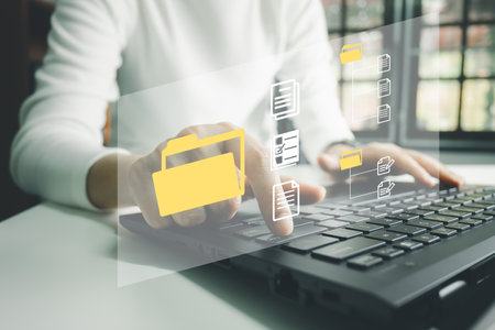 Officer using laptop manage files, Document Management System (DMS), Online document database management, automated processes to manage system, ERP enterprise efficient, business technology.の写真素材