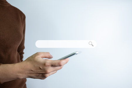 Search Engine optimization SEO concept, Businesswoman is using smartphone to search for information on Internet, Using the search bar, Wireless Network, big data and accessing website information.の写真素材