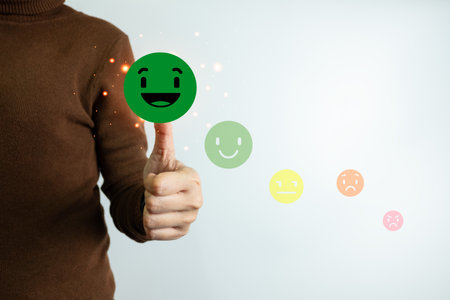 Customer satisfaction concept, client is satisfied with pressing the smiley face icon, excellent service, impressed with care, highest rating and score, good feedback from users.の写真素材