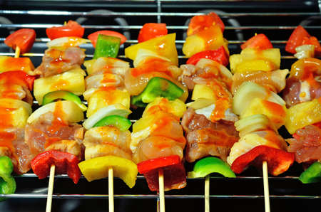 Bar-B-Q or BBQ with kebab cooking. coal grill of chicken meat skewers with mushroom and peppers. barbecuing dinnerの写真素材