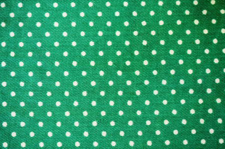 Green polka dot fabric in full frameの写真素材