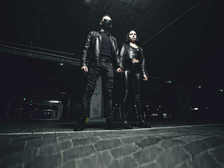 Masked man standing with a woman
